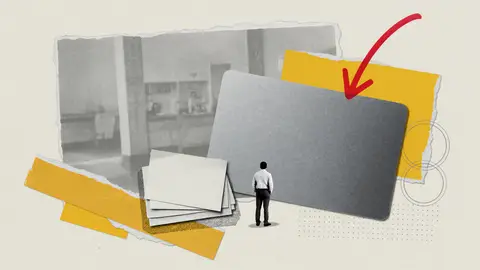A giant blank metal charge card beside a smaller stack of blank paper, with one red arrow pointing down, for American Express.