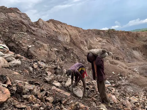 Artisanal miners with sacks of ore in an open cobalt pit near Kolwezi, Democratic Republic of Congo