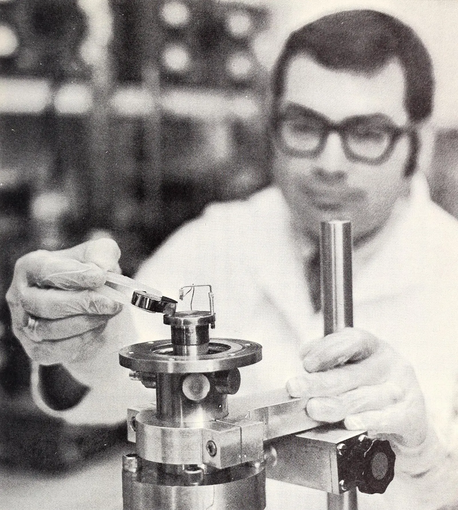 A germanium wafer held in tweezers above a cryostat at the US National Bureau of Standards