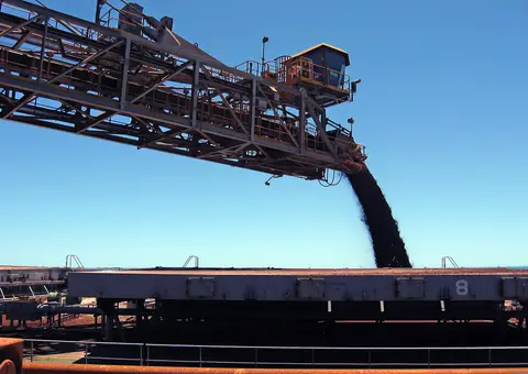 A Rio Tinto shiploader pours iron ore into a bulk carrier hold at a Pilbara export terminal