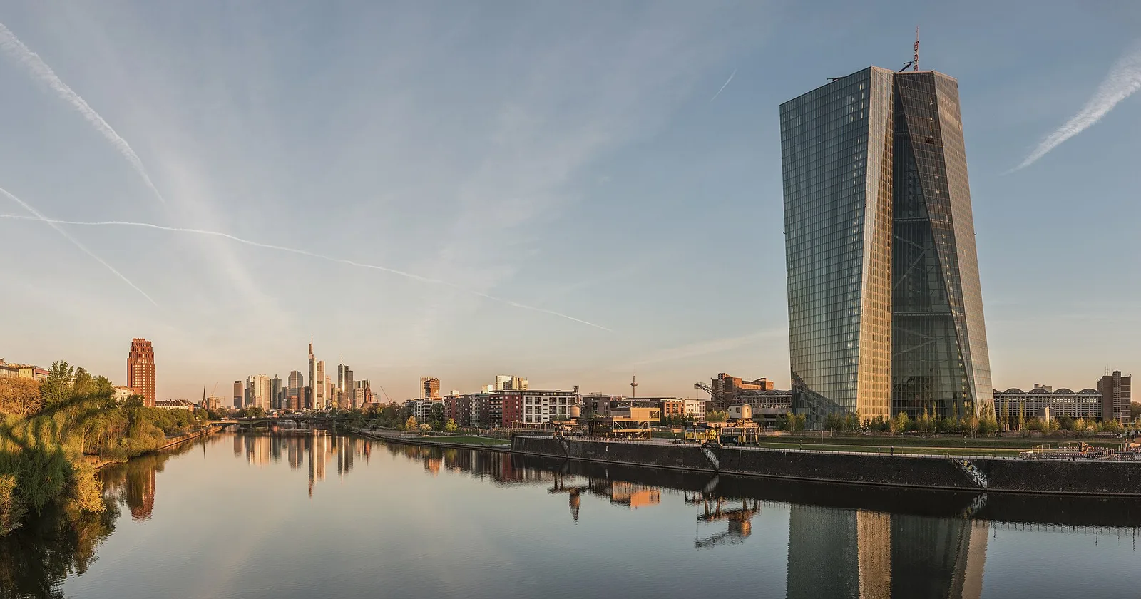 The Seat of the European Central Bank on the river Main at dawn, with the Frankfurt banking skyline behind it