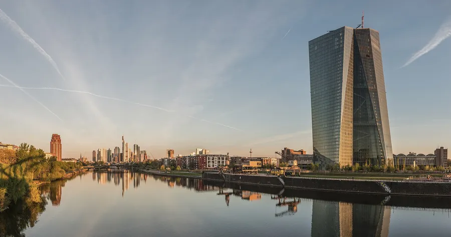The Seat of the European Central Bank on the river Main at dawn, with the Frankfurt banking skyline behind it