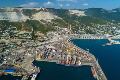 Aerial view of the NUTEP and KSK terminals at the port of Novorossiysk on Russia's Black Sea coast, with grain silos on the quayside