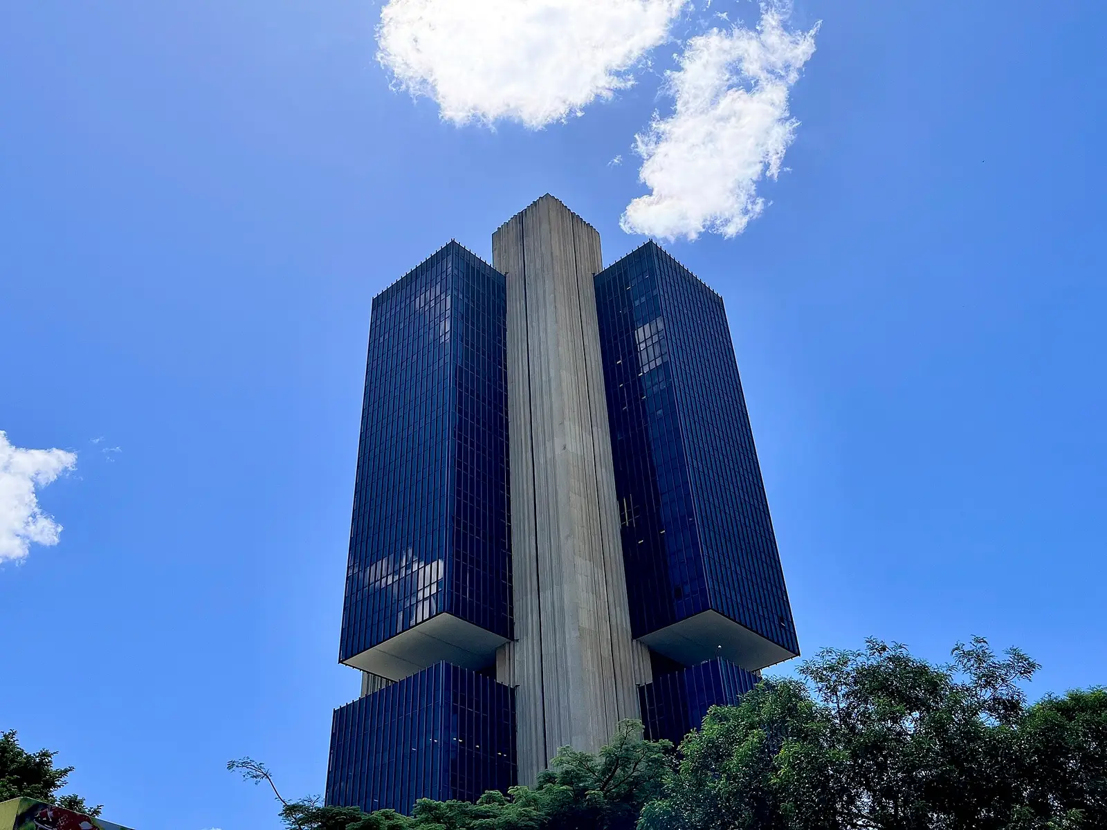 The Banco Central do Brasil headquarters tower in Brasilia, seen from below against a blue sky