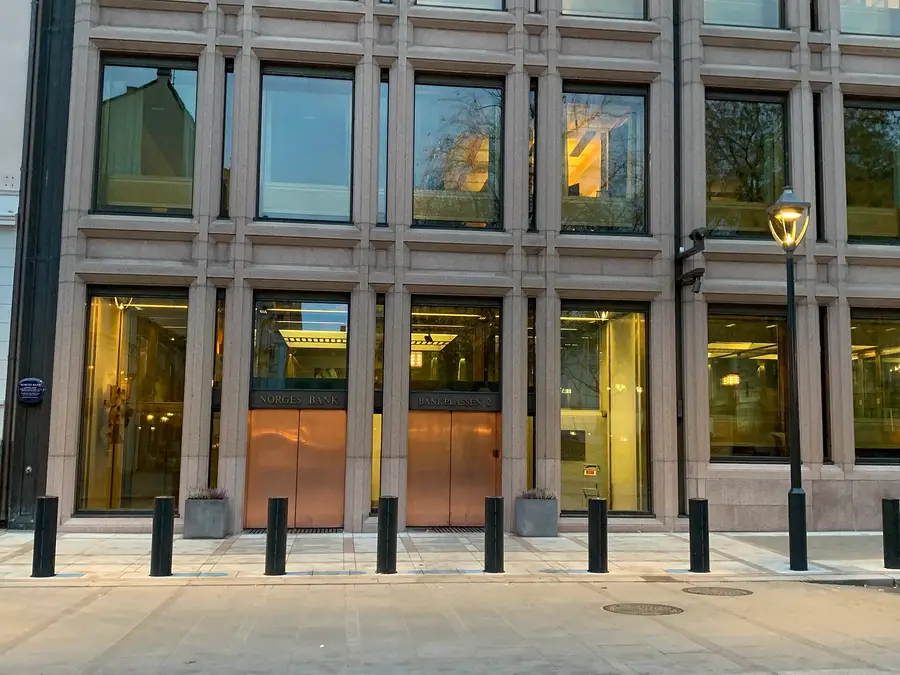 Norges Bank headquarters at Bankplassen 2 in Oslo, with copper doors and the bank's name above the entrance.
