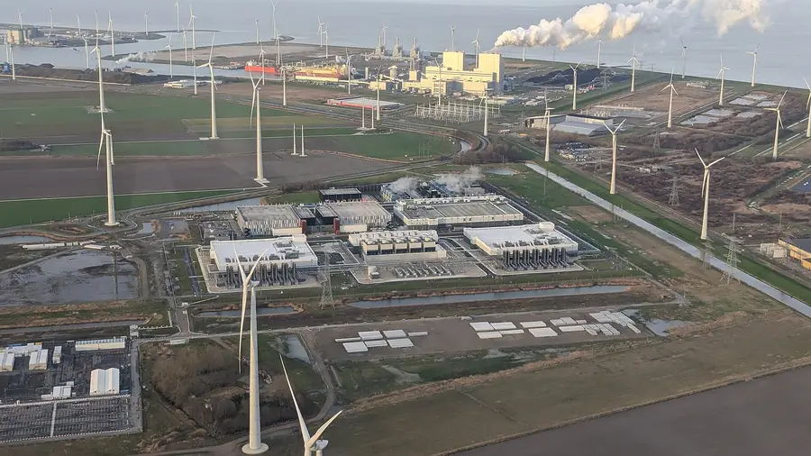 Aerial view of Google's Eemshaven data centre in the Netherlands, ringed by wind turbines and a power plant