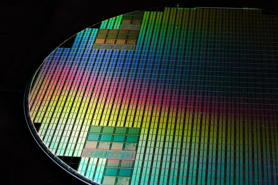 Close-up of a patterned 300mm silicon wafer showing the grid of individual dies before singulation