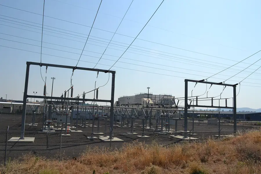Electrical substation and transmission structures in front of a data-center building