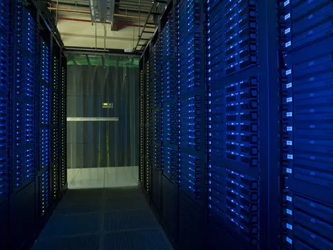 Server racks lining an aisle in the Fermilab grid computing centre