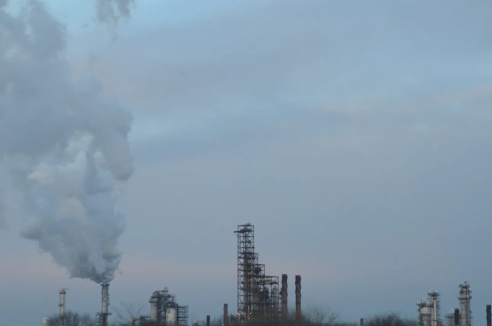 ExxonMobil refinery next to Interstate 55 near Joliet, Illinois, with a steam plume over the process units