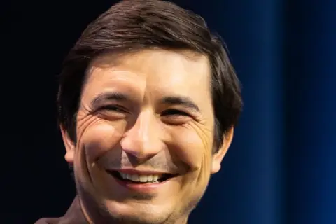 Robinhood chief executive Vlad Tenev on stage in 2025, whose Robinhood Chain became the largest source of Uniswap protocol fees