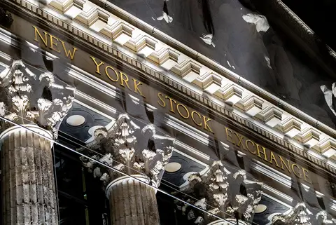 Gilded New York Stock Exchange lettering on the Broad Street facade at night, home of the NYSE Arca listing venue named in the Bitwise NEAR ETF filing
