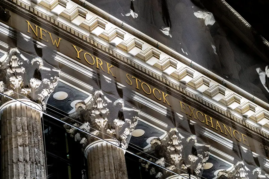 Gilded New York Stock Exchange lettering on the Broad Street facade at night, home of the NYSE Arca listing venue named in the Bitwise NEAR ETF filing