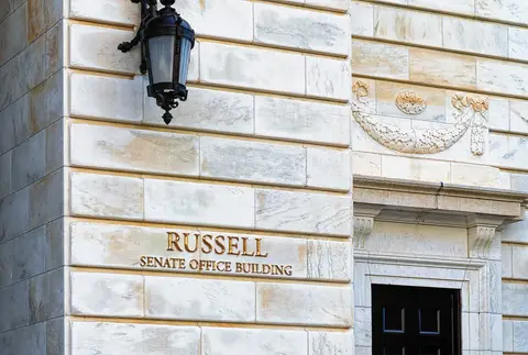 Gold lettering reading Russell Senate Office Building on the marble facade of the Senate office building in Washington DC