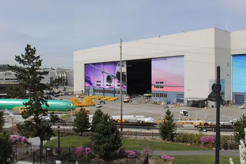 Boeing 737 factory in Renton, Washington, with a 737 fuselage and wing assemblies on the apron