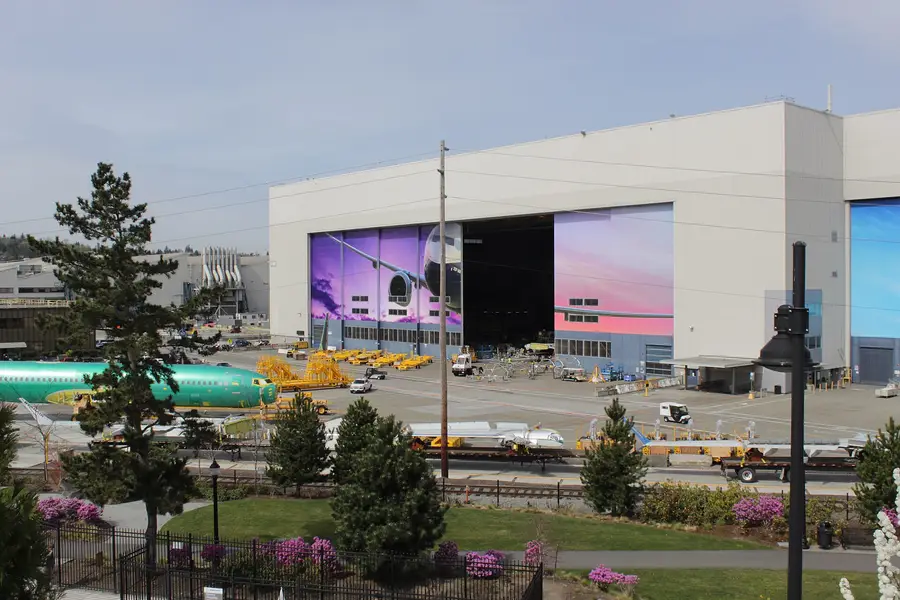 Boeing 737 factory in Renton, Washington, with a 737 fuselage and wing assemblies on the apron