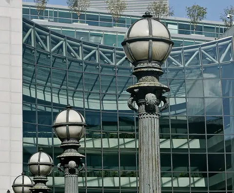 Glass facade of the U.S. Securities and Exchange Commission headquarters at 100 F Street NE in Washington D.C. seen behind period street lamps