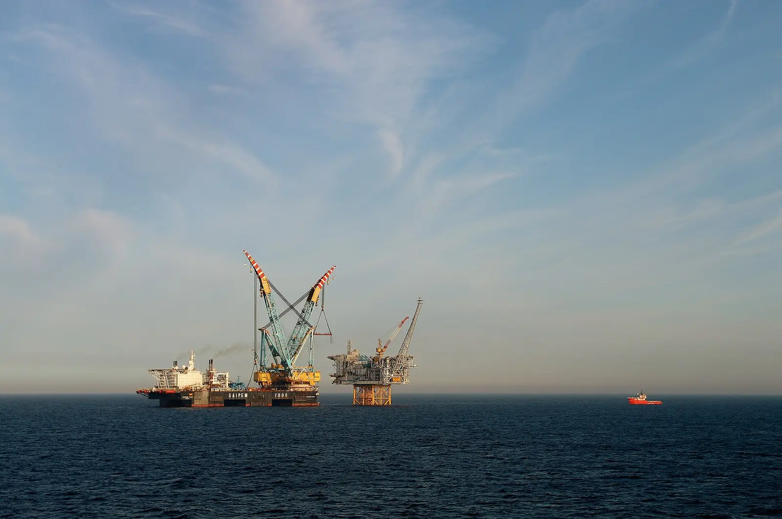 The Ivar Aasen platform deck being installed in the Norwegian North Sea by the Saipem 7000 crane vessel, with a supply ship alongside