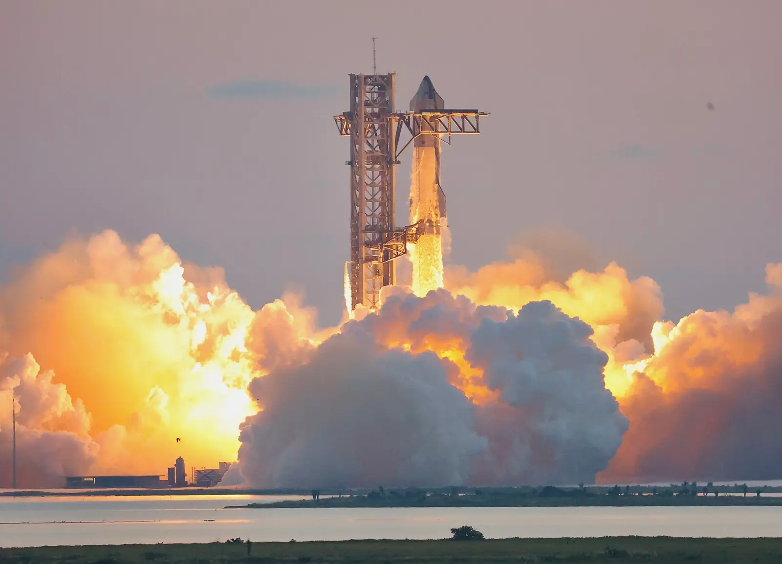 SpaceX Starship lifting off from the Starbase launch tower in Texas during its fifth integrated flight test