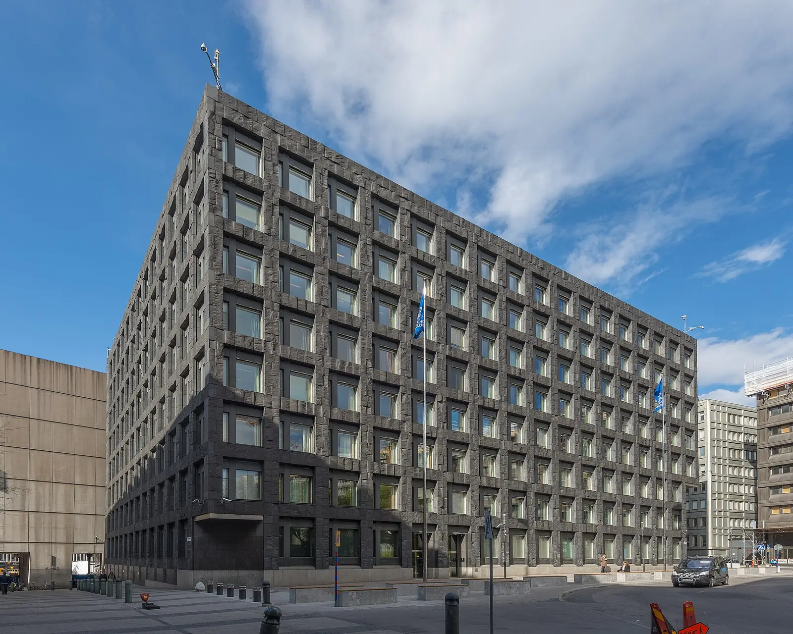 The Riksbank headquarters at Brunkebergstorg in Stockholm, a dark stone block under a blue sky