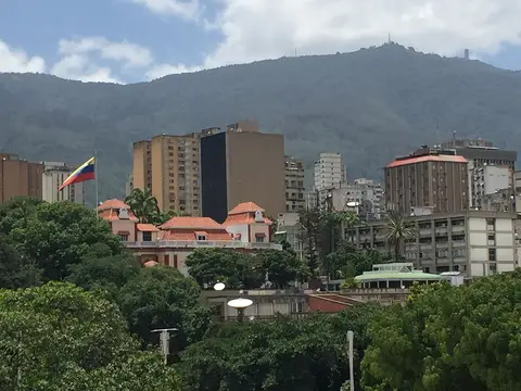 The Miraflores Palace in Caracas, seat of the Venezuelan presidency, with the national flag flying above the city