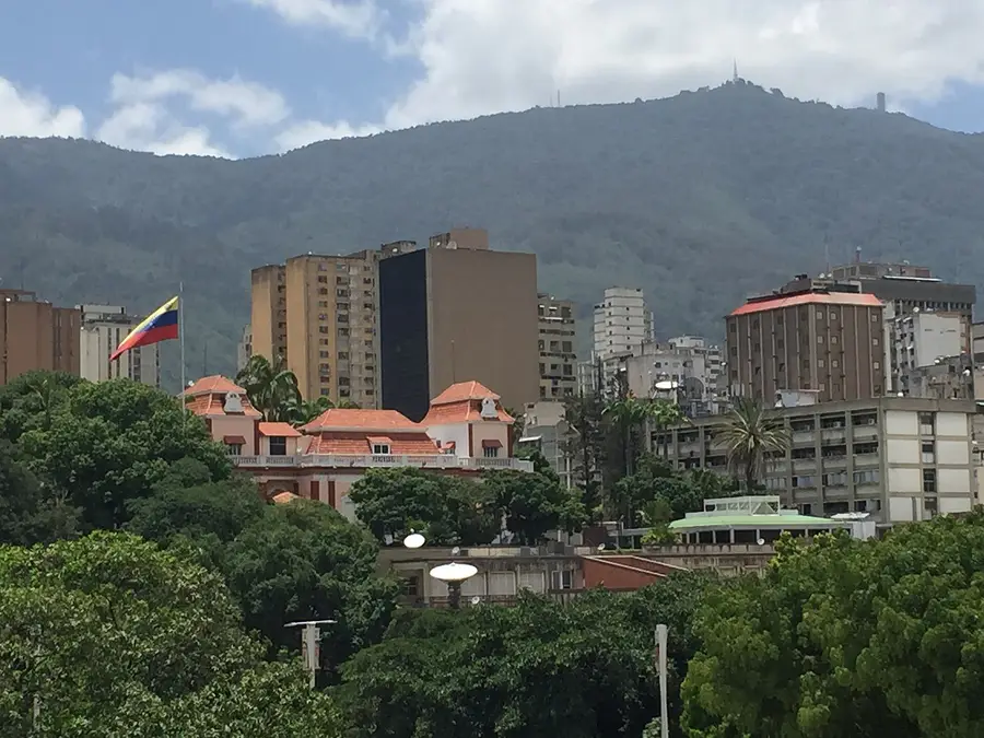 The Miraflores Palace in Caracas, seat of the Venezuelan presidency, with the national flag flying above the city